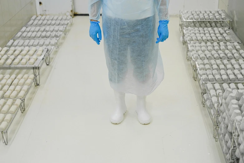 a man standing inside of a warehouse covered in plastic