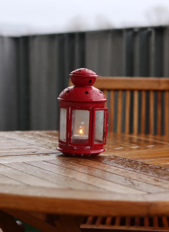 an old fashioned lantern sitting on a table outside