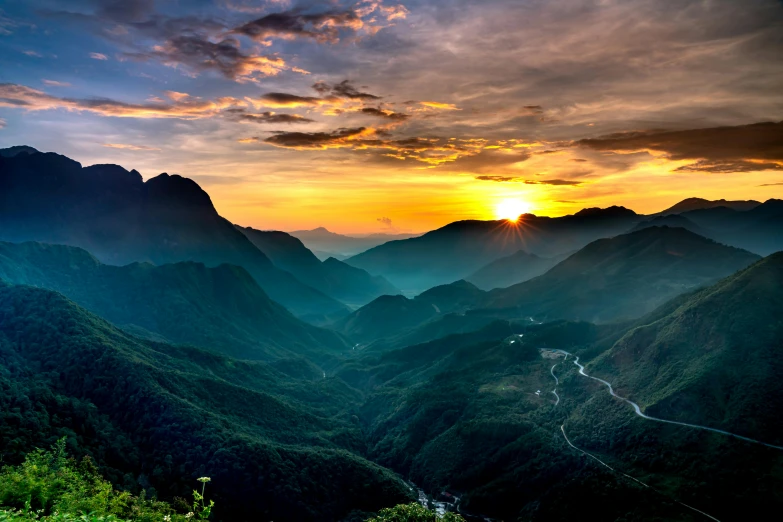 a sunset is shown over the mountains with clouds