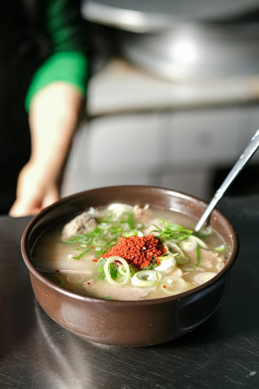 a bowl of soup sits on a table