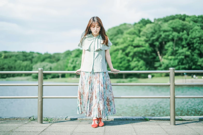 an image of a woman that is standing by water