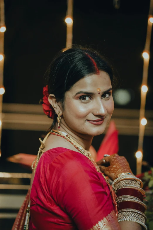 a woman in a red outfit standing with lights