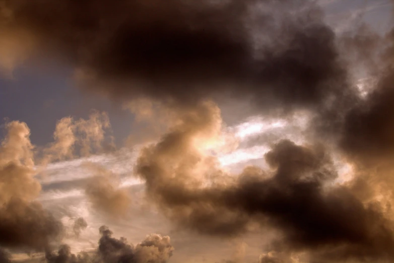 clouds form a dark, cloudy sky as the sun sets