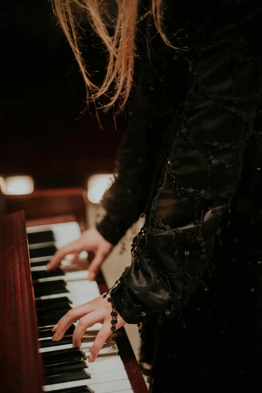 the woman is playing on the piano