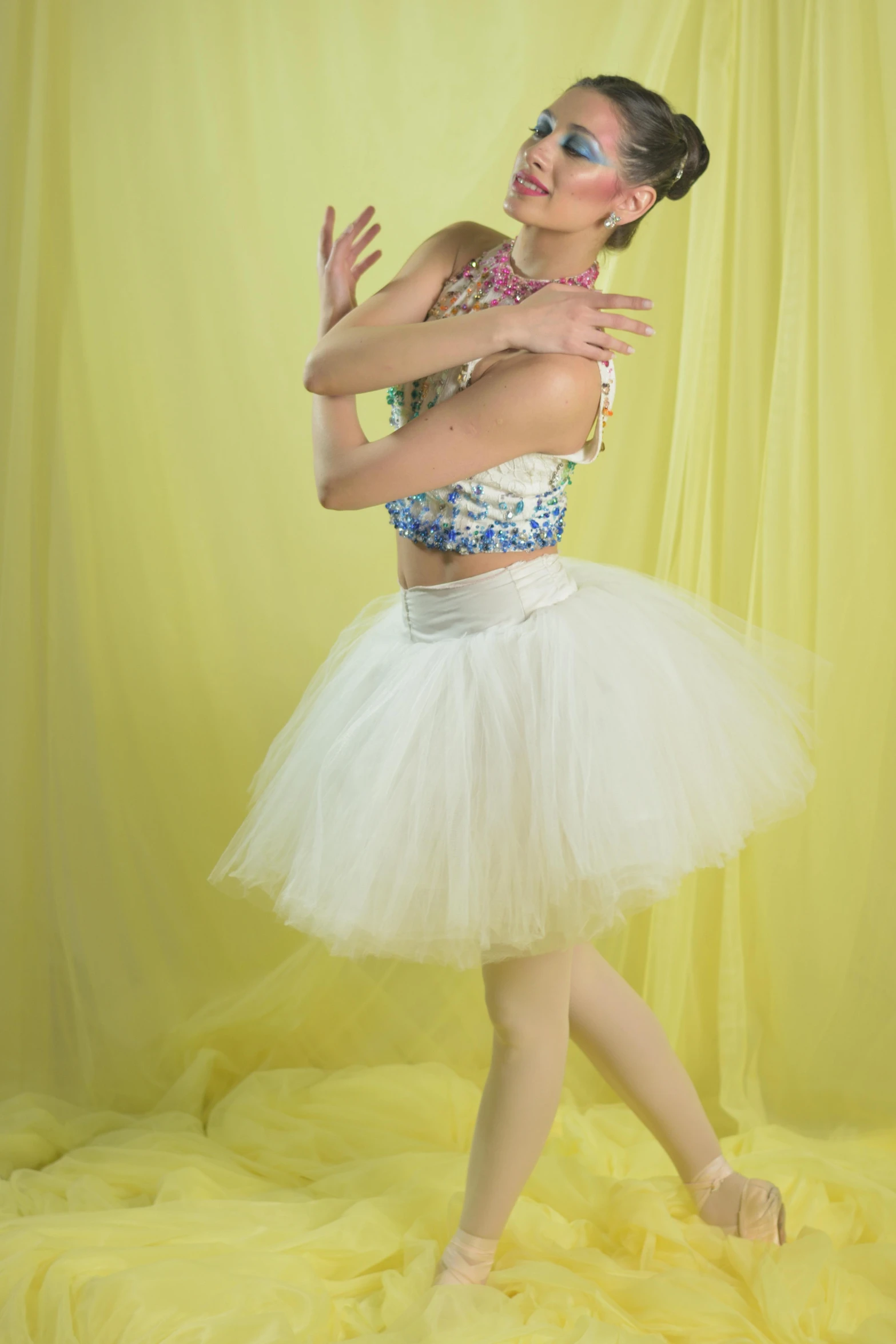 young woman in white and blue outfit doing aerial acrobatic dance