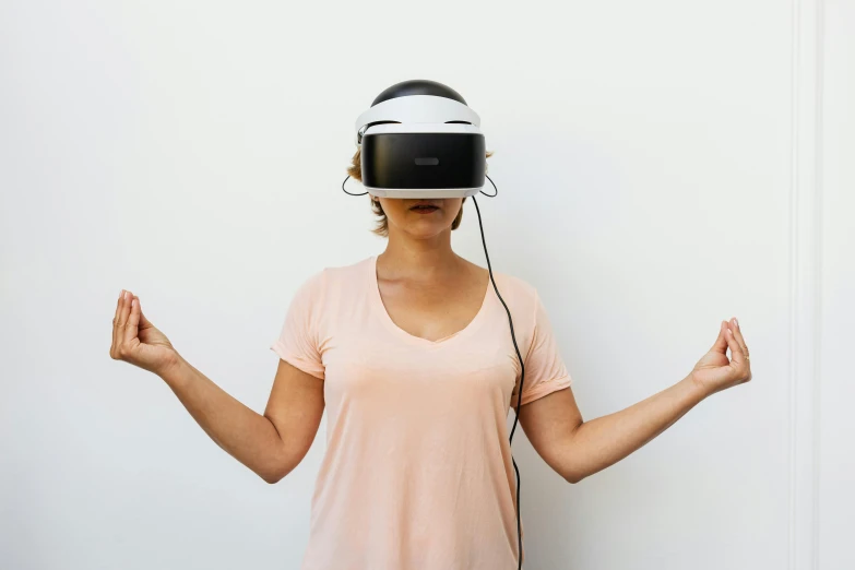 a woman is holding hands with her hands and wearing a virtual headset