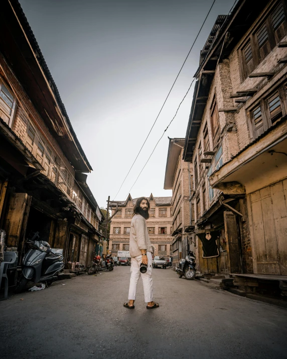 an asian woman walks through the old town streets