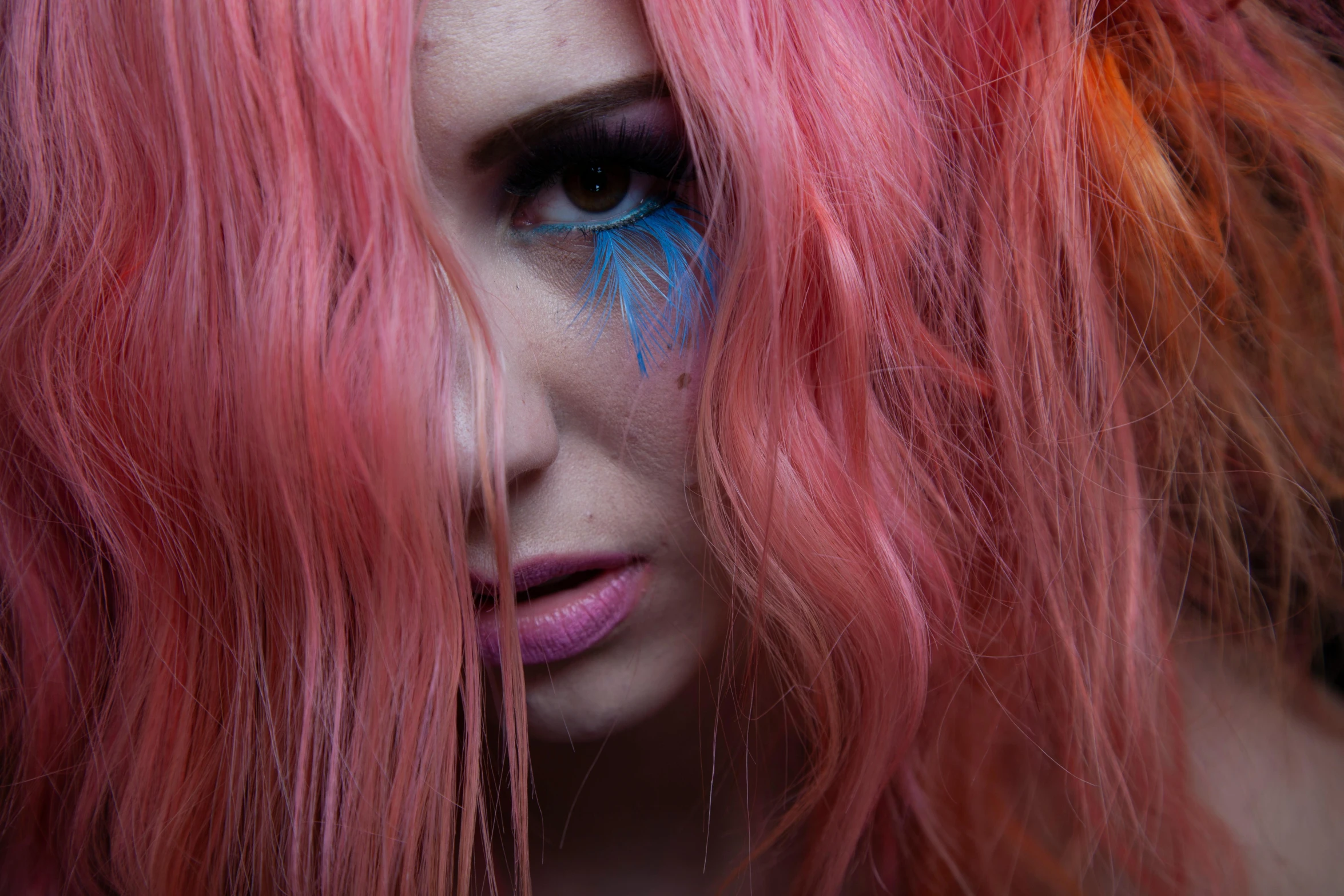 a woman with long pink hair has painted on her face