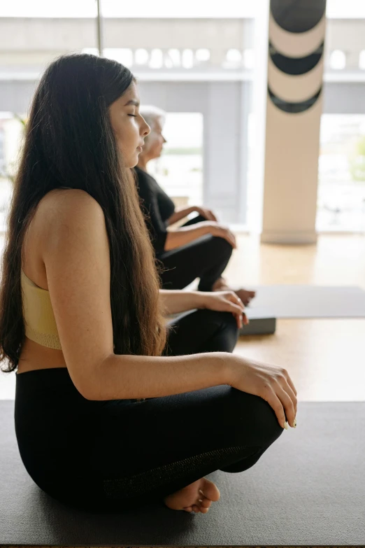 some women doing yoga poses in a line