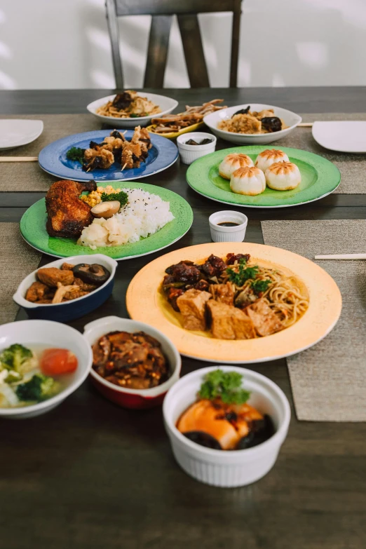 a table full of food and rice dishes