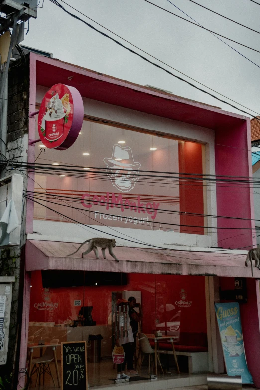 a storefront with colorful striped buildings and wires in the background