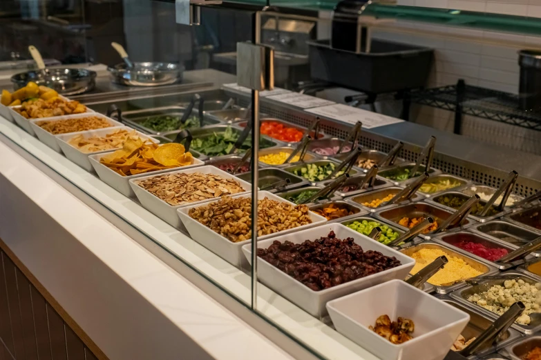 a selection of salads in the buffet area of a building