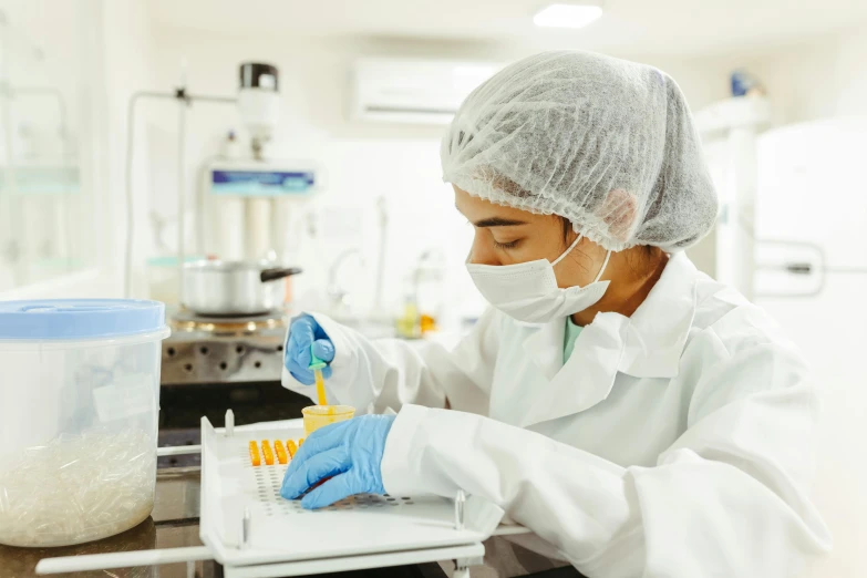 a man in a white lab coat holding a toothbrush and a flask in front of him