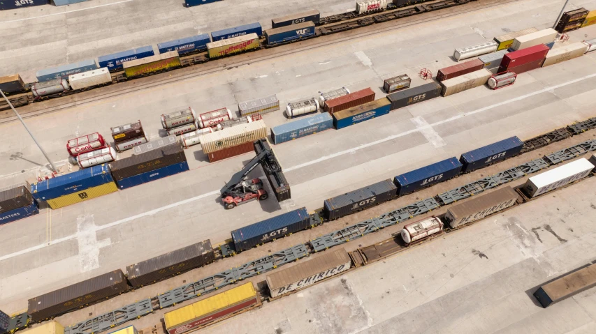 train tracks running parallel to each other with trains at them