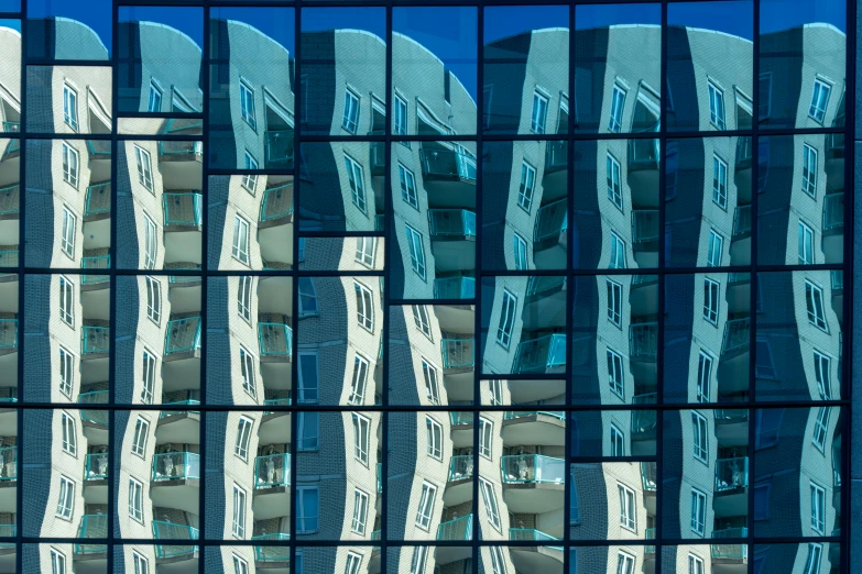 the reflection of buildings in the windows of a building