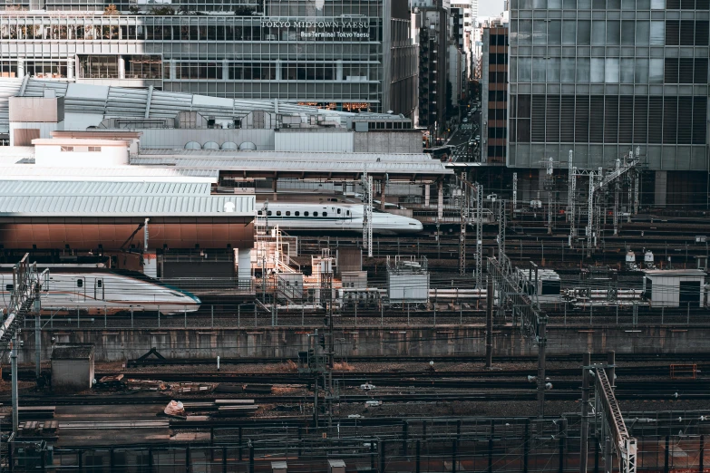 a city scene with a train station and buildings