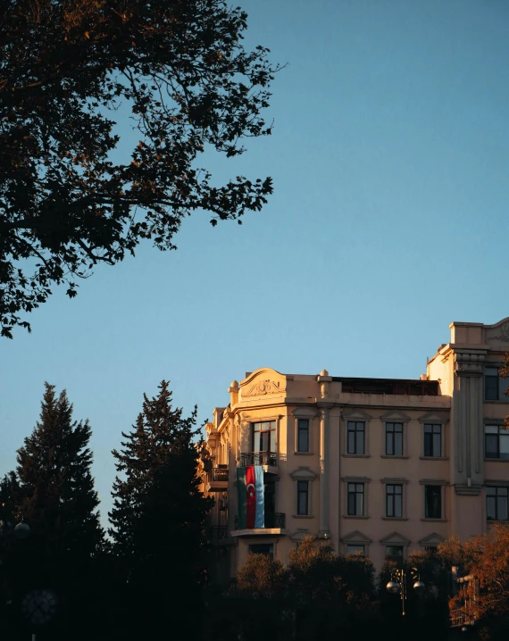 a large building sitting on top of a tree covered hillside