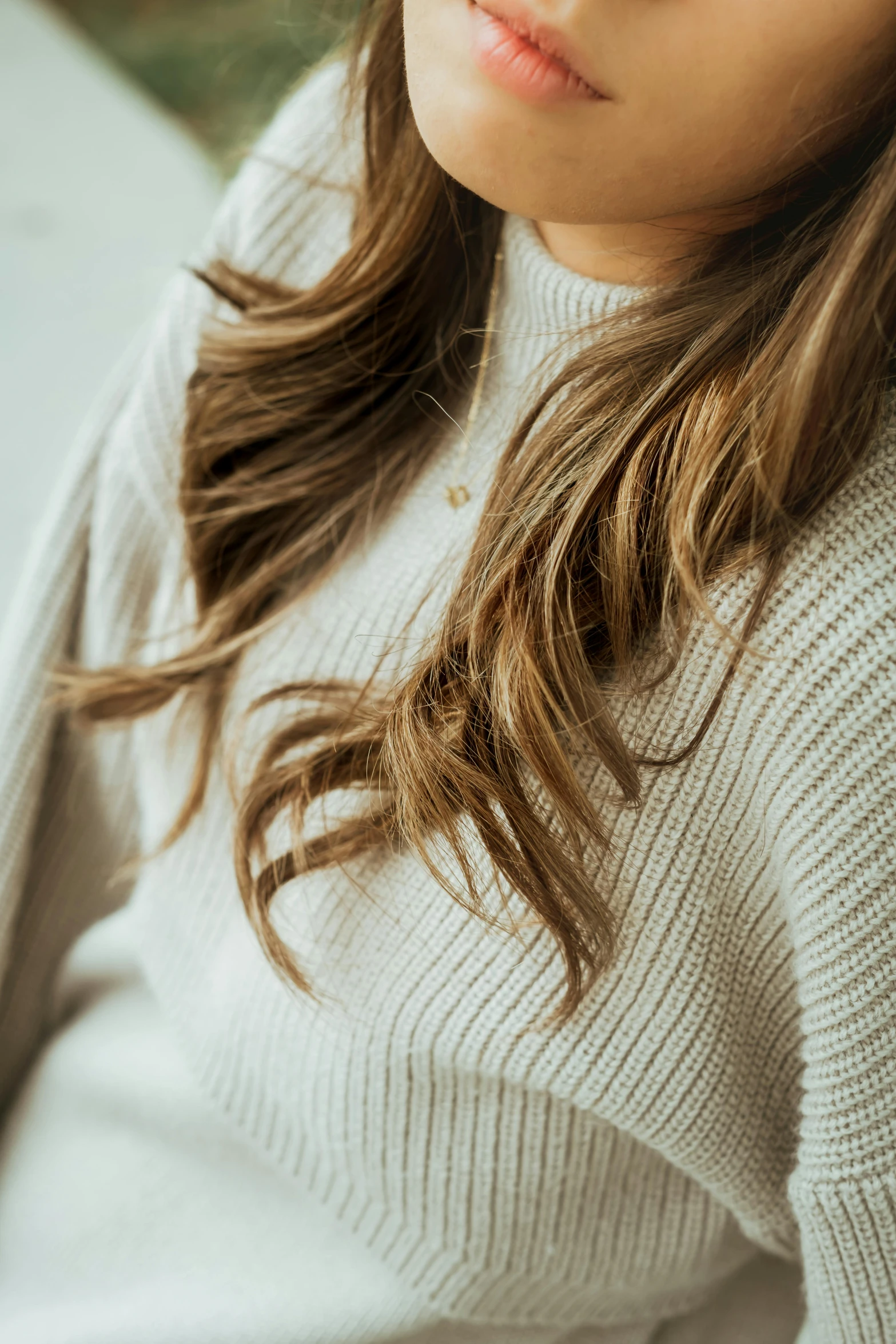 a girl with a sweater on posing for a picture