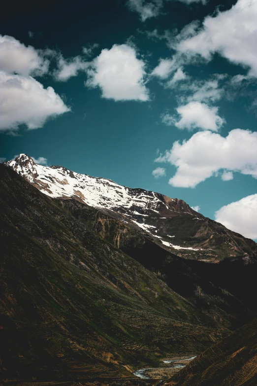 mountain with snow covered top against clear blue sky