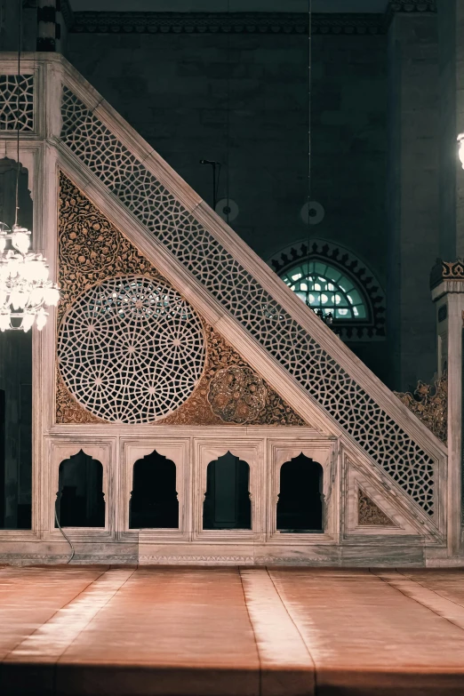 a stair case with ornate design next to chandelier