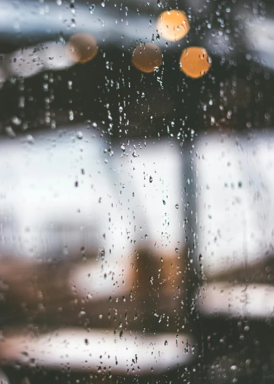 looking out the window at rainy traffic behind a street light