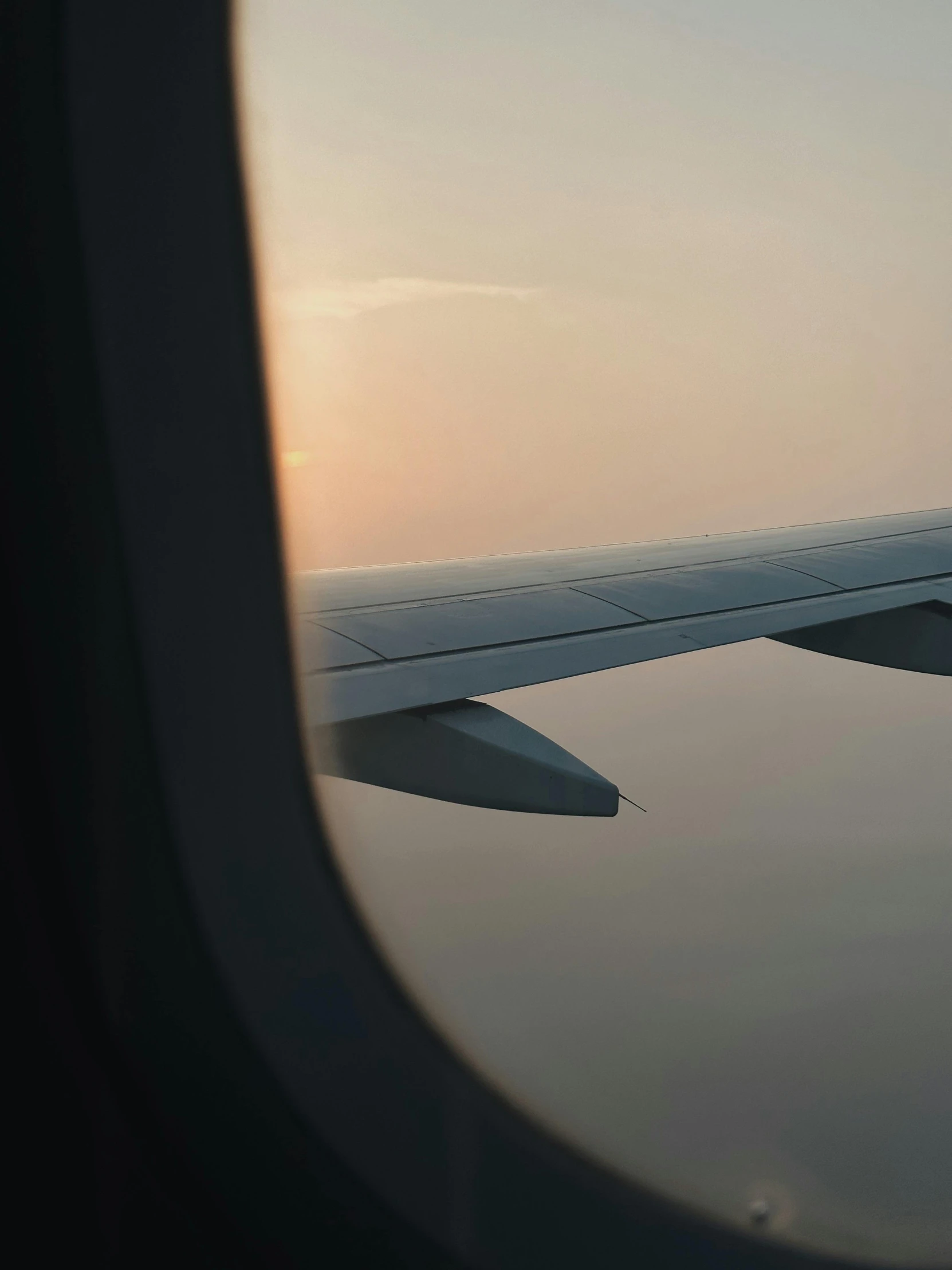 an airplane wing in the sky and water