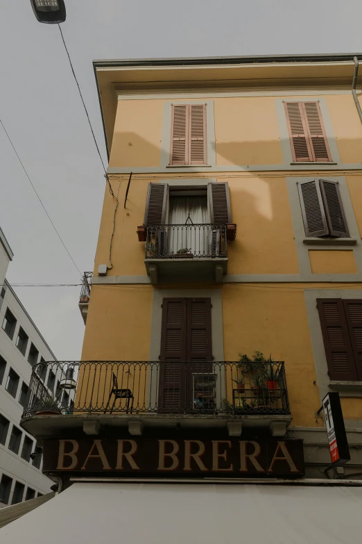 a yellow building with lots of open windows