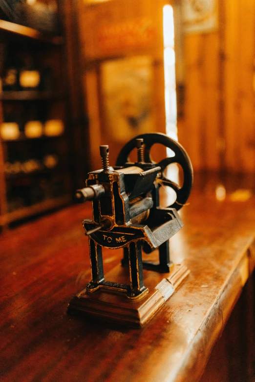 an old metal device sitting on top of a wooden counter