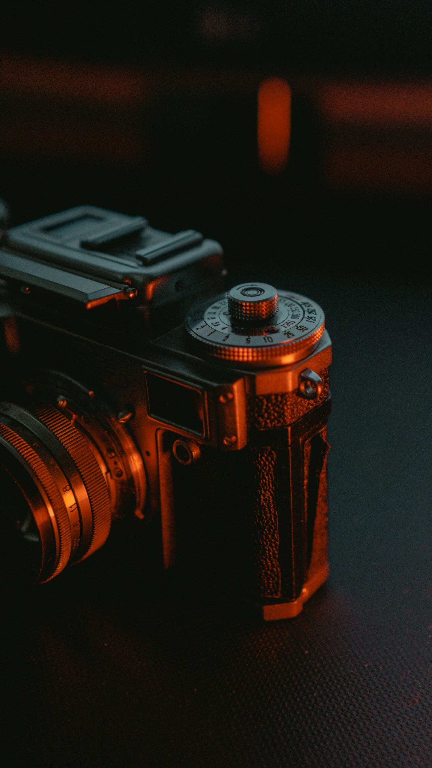 an old, black camera with bright orange flash lights