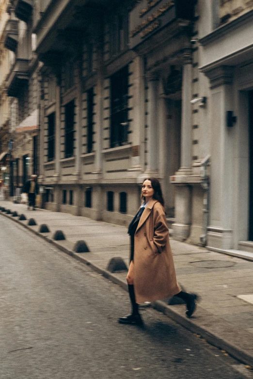 a woman is walking down a long, empty street