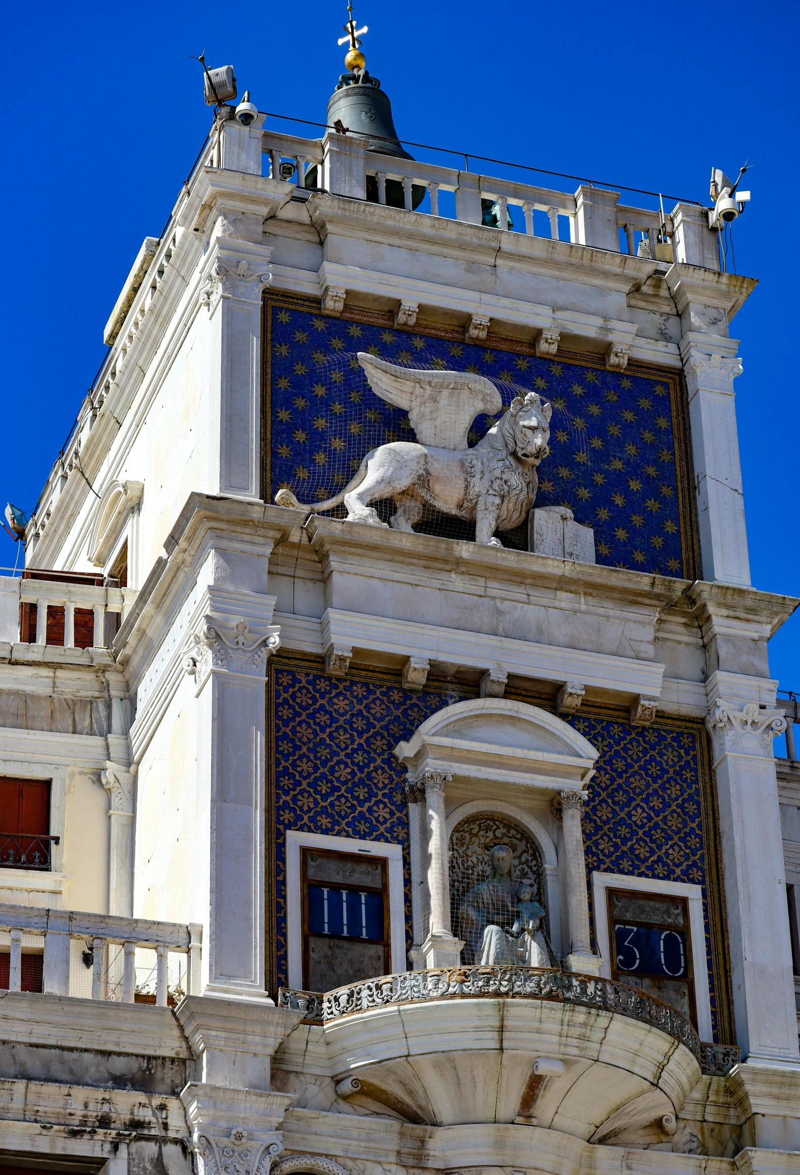 an elaborate white building with some blue tile on the outside