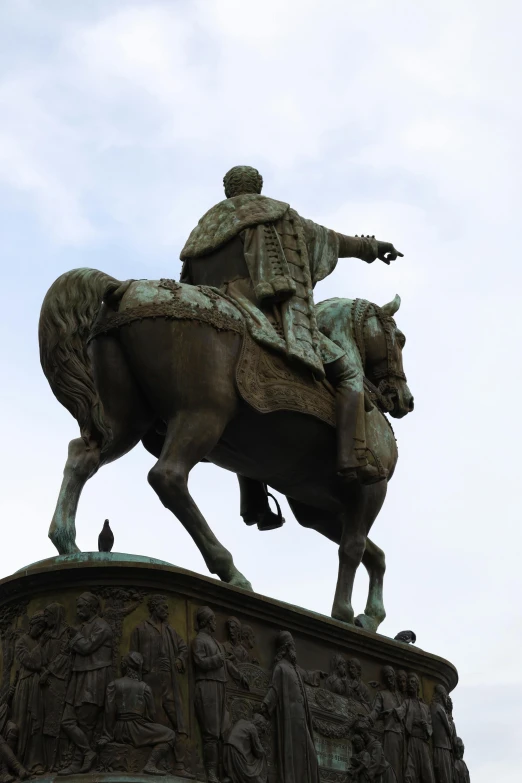 a statue of a man on a horse on top of a fountain