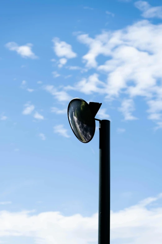 the street light is lit with a clear sky