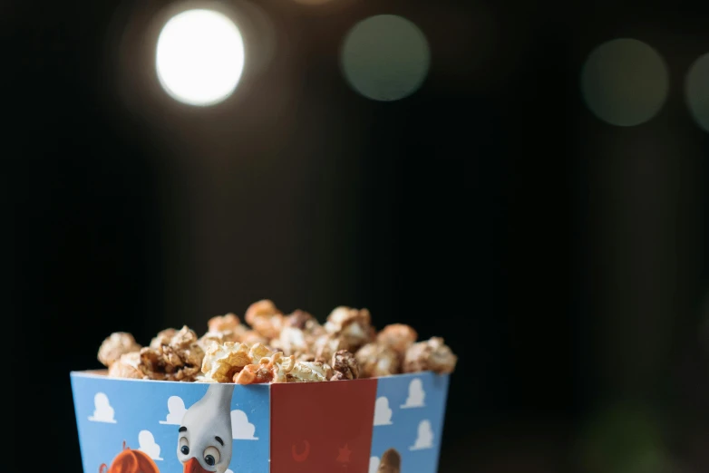 a blue popcorn container with brown cereal in it