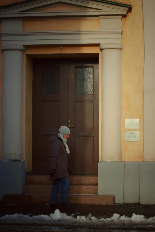 a man walking into a door of a building