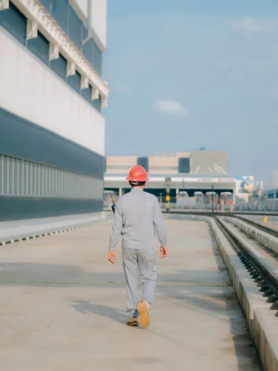 there is a young person walking alone holding his hand on his hip