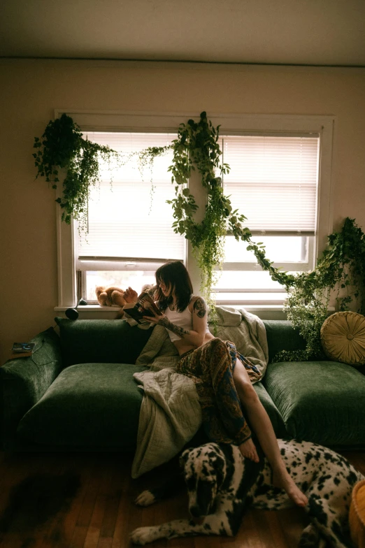 a woman is on a couch with her dog