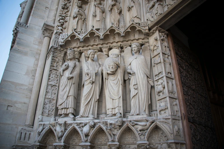 a large statue that is next to an archway