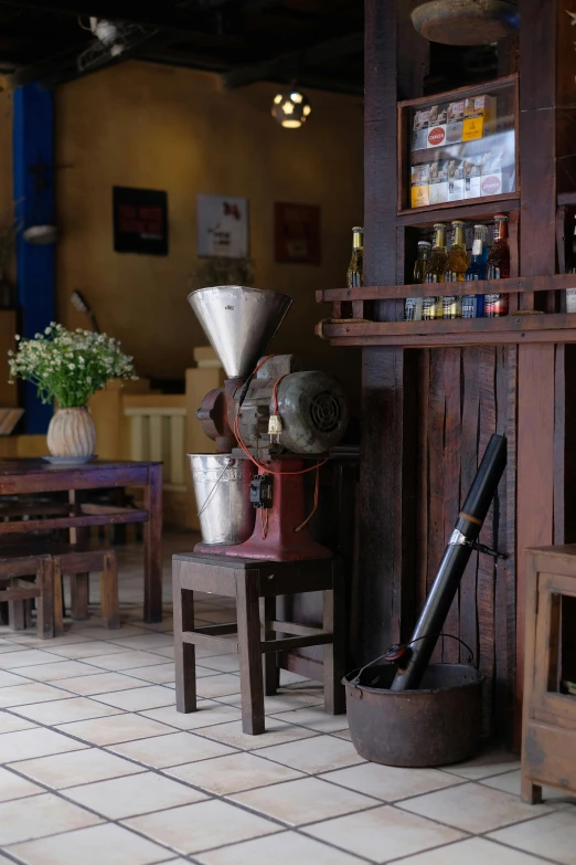 there is a coffee grinder and chair in this coffee shop