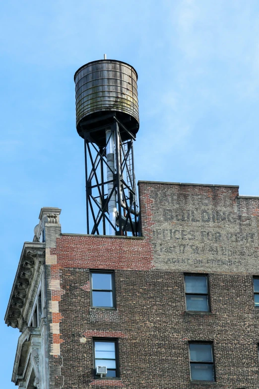 an old brick building with a water tower on top