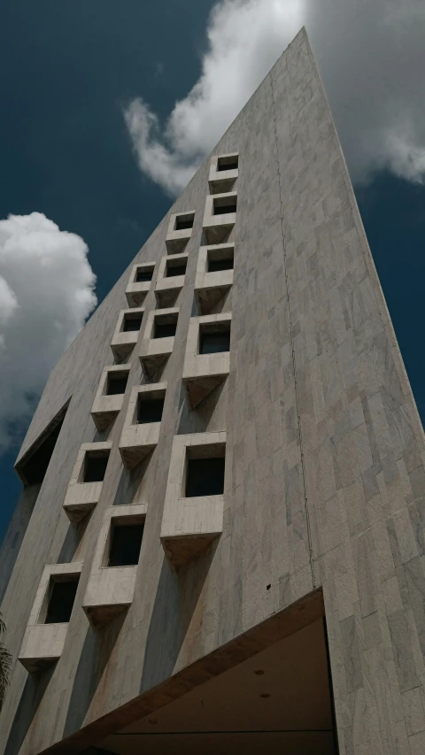 the top portion of a building in front of clouds