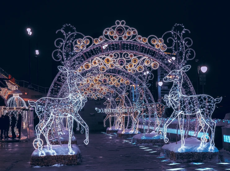 lighted horses are walking through an open doorway