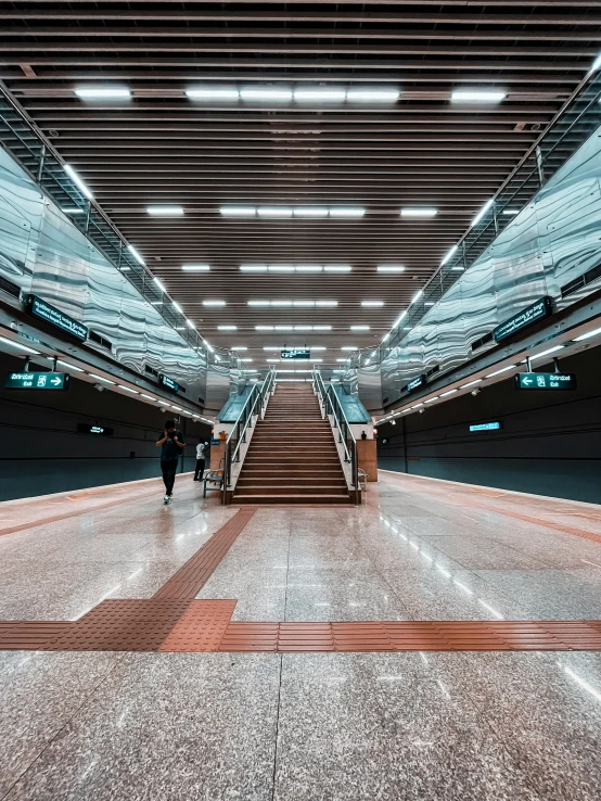 a big escalator going up a set of stairs