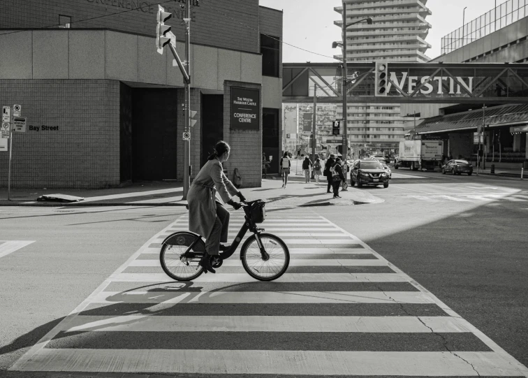 there is a man that is riding a bike on the street