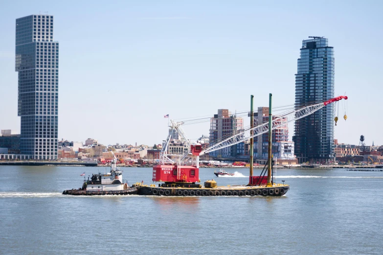 a barge with some cranes on the back in the water