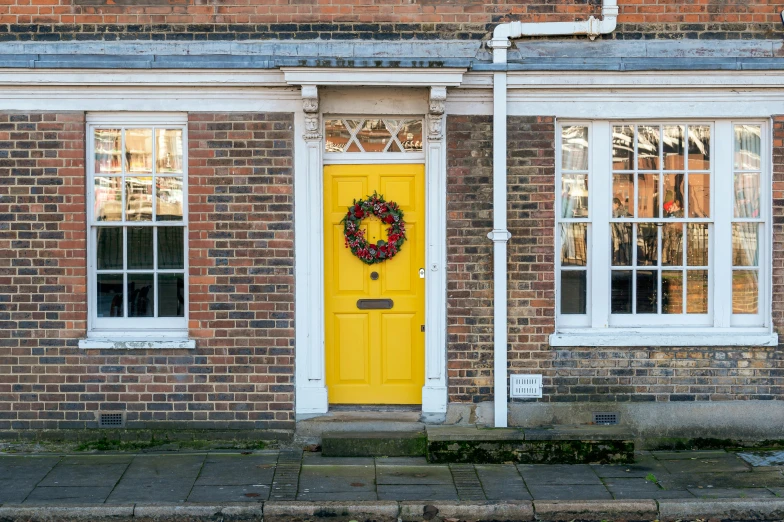 a house with yellow door and white windows