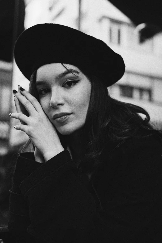 a black and white po of a woman in a hat