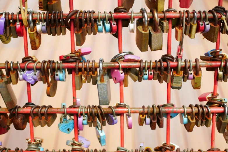 many metal objects hanging on a red wall