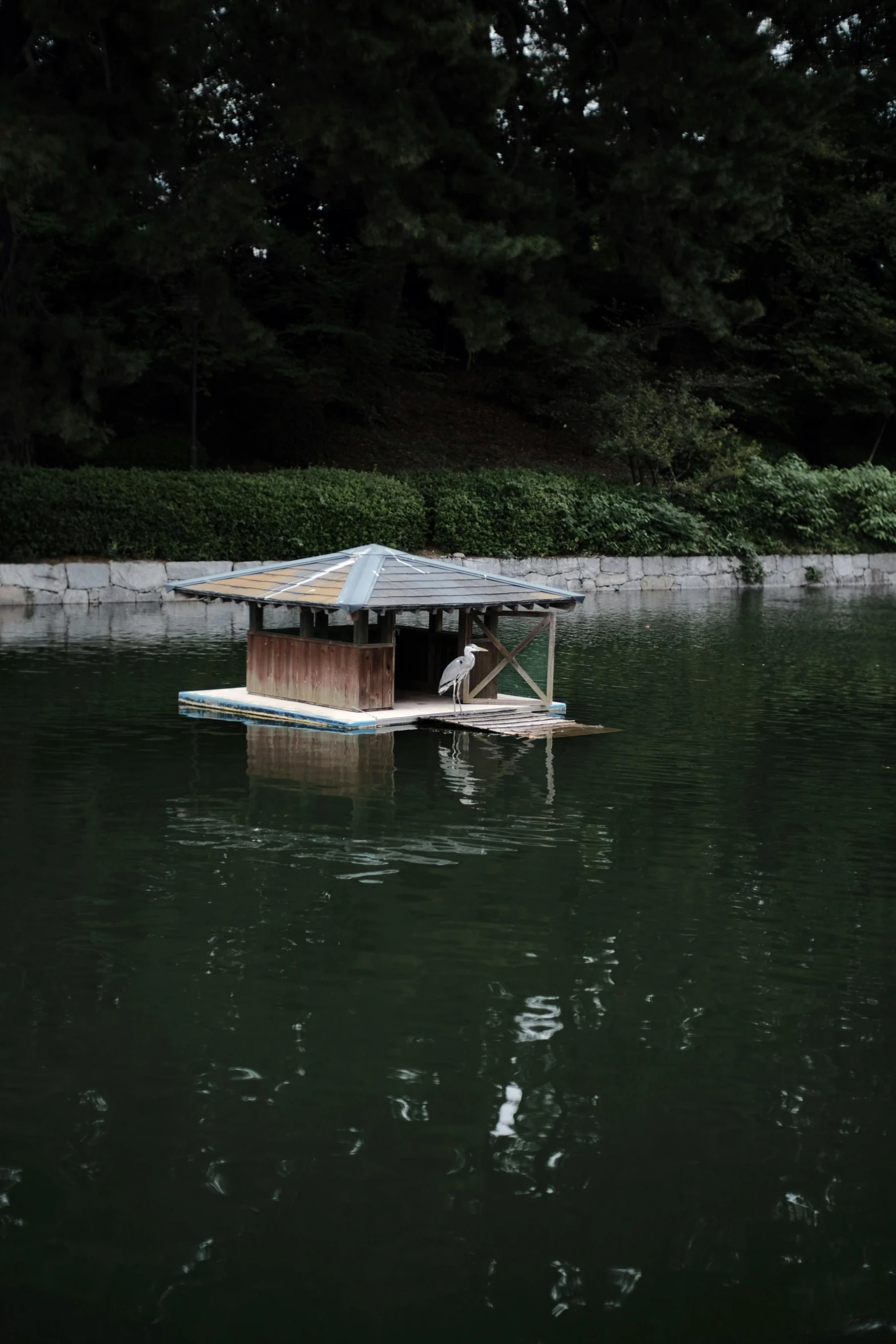 a boat house floating on top of water