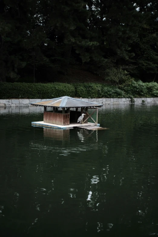 a boat house floating on top of water